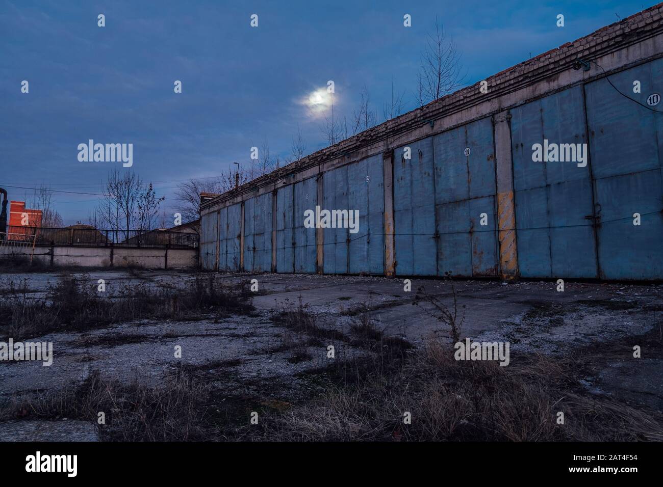 Old abandoned truck or tractor garages at night Stock Photo