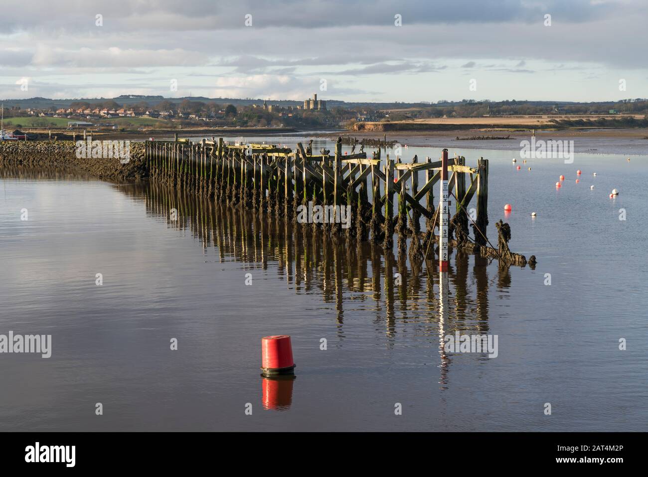 Amble harbour and old jetty with view to Warkworth Castle, Northumberland. Stock Photo