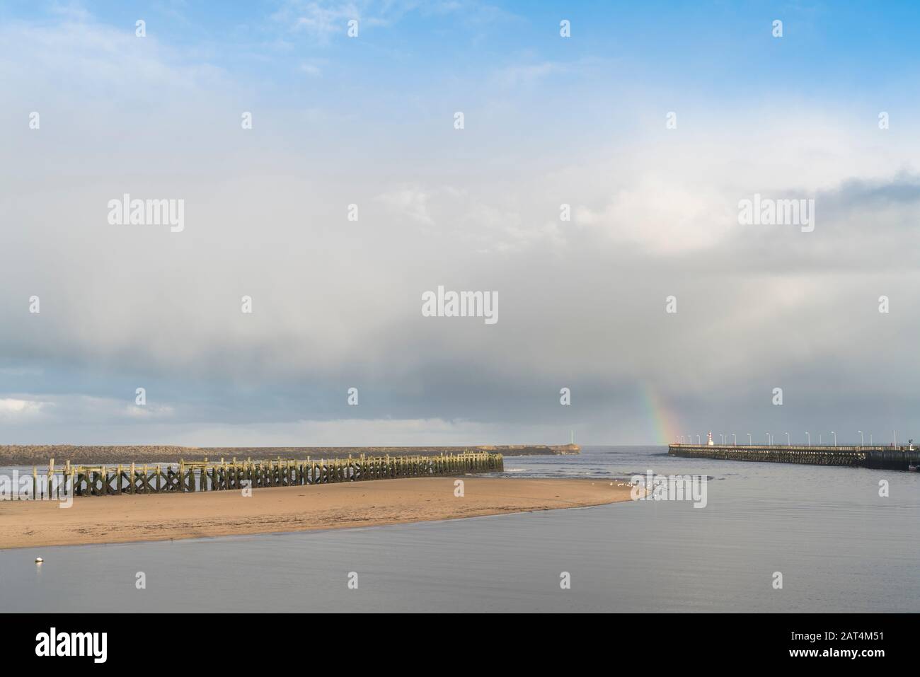 Rainbow at entrance to Amble harbour, Northumberland Stock Photo