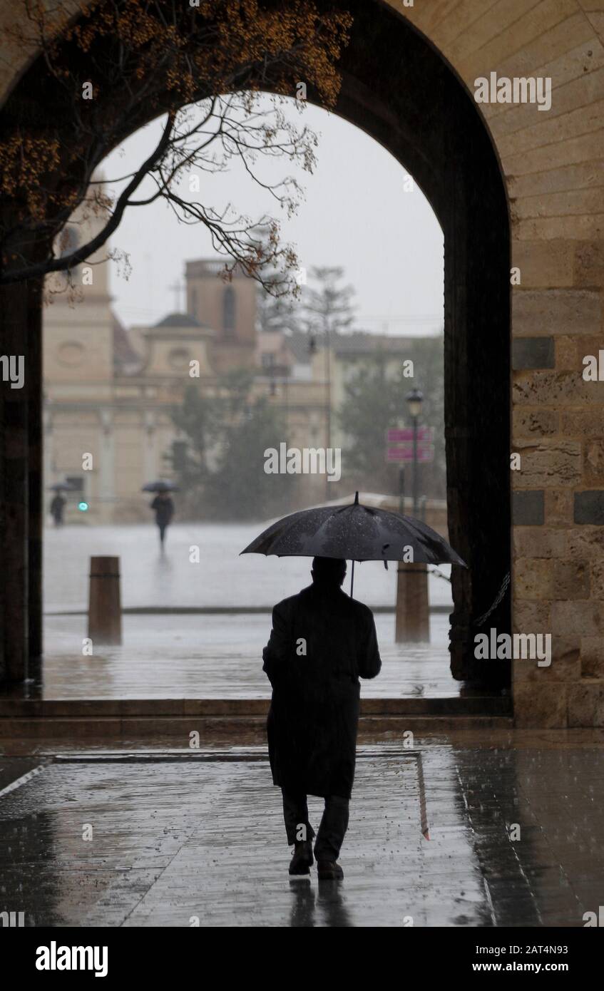 A man walks in a rainy day in Valencia. Stock Photo