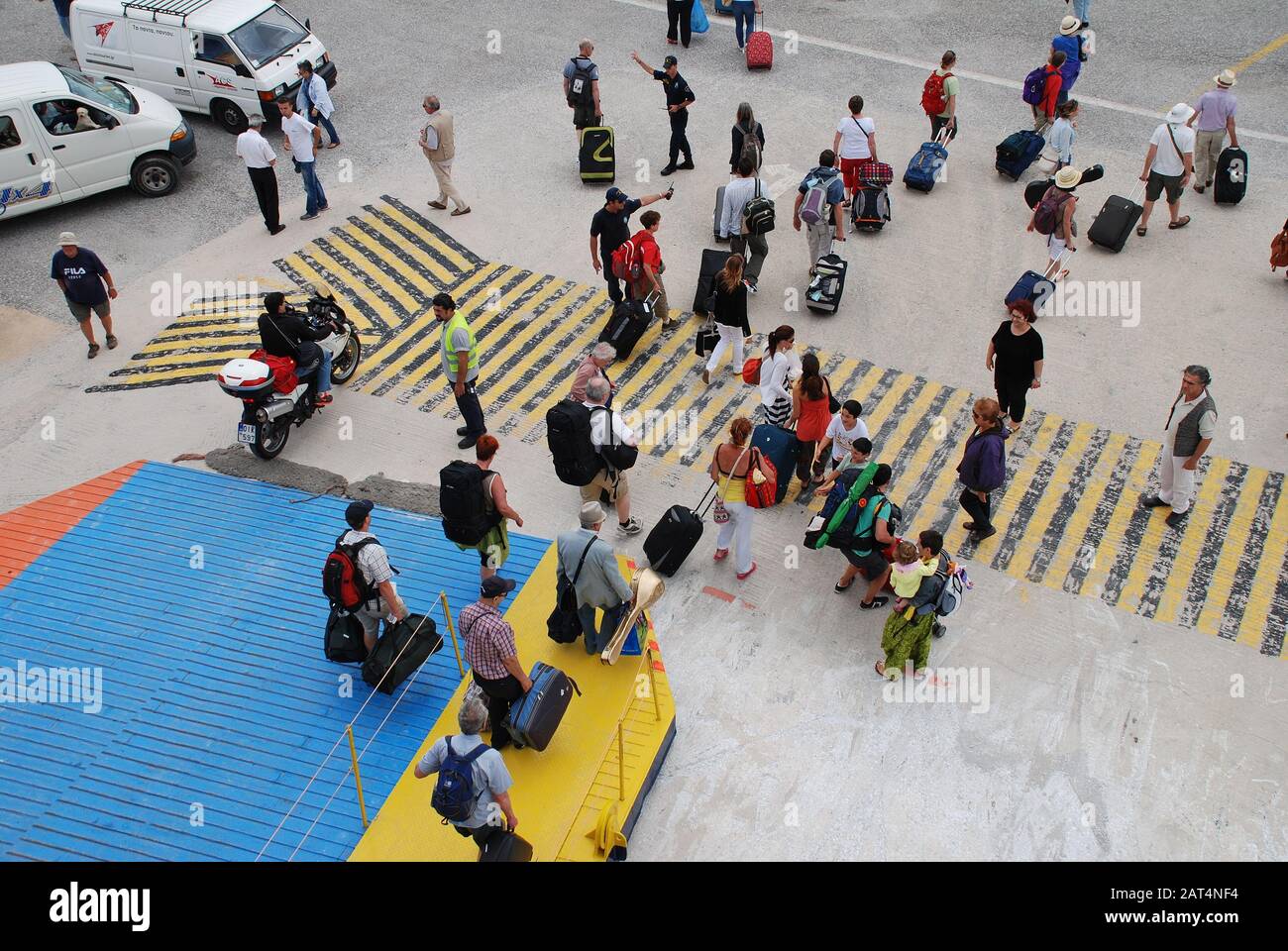 Passengers disembark from a ferry docked at Skopelos Town harbour on the Greek island of Skopelos on June 14, 2013. Stock Photo