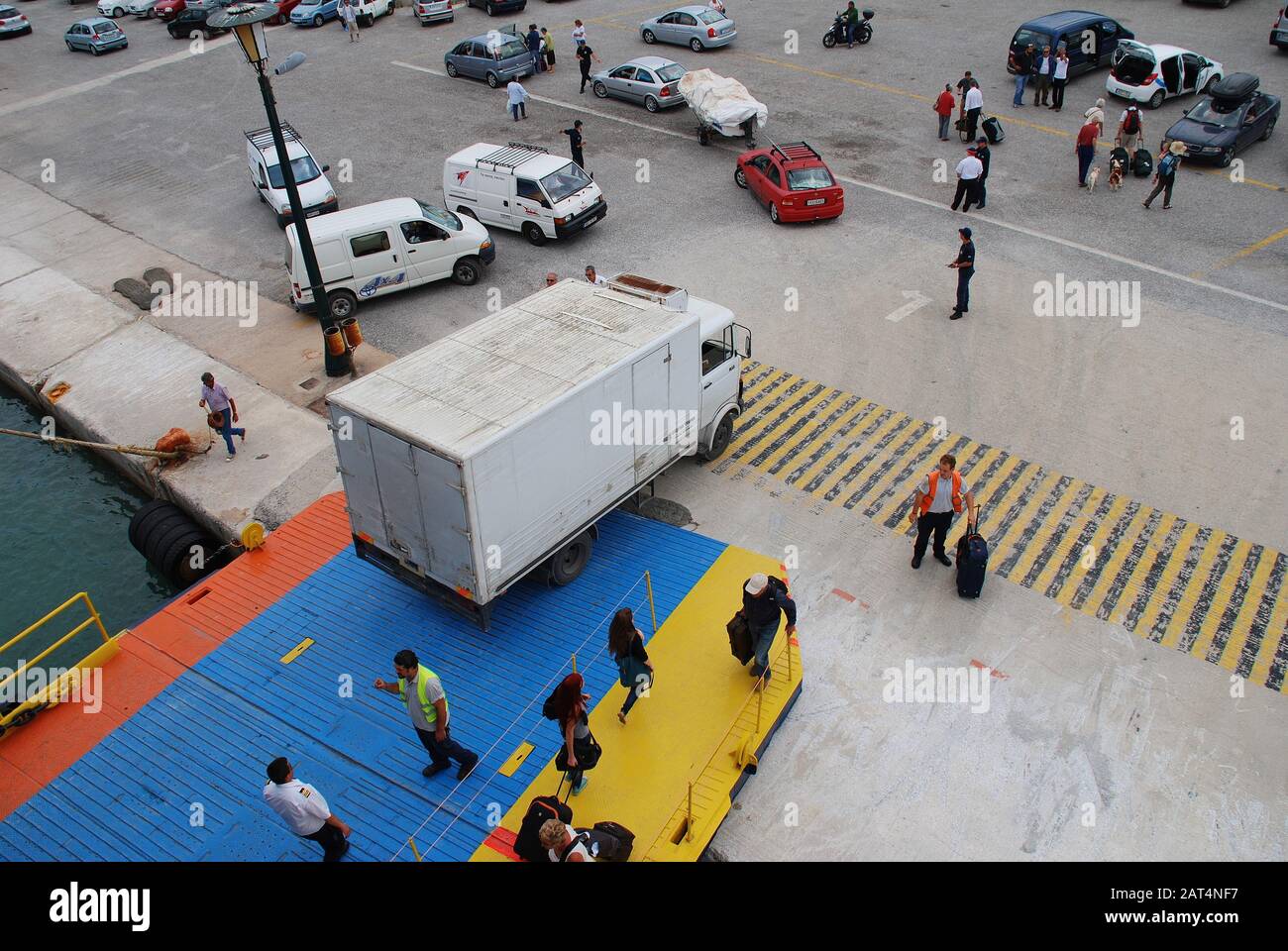 Passengers disembark from a ferry docked at Skopelos Town harbour on the Greek island of Skopelos on June 14, 2013. Stock Photo