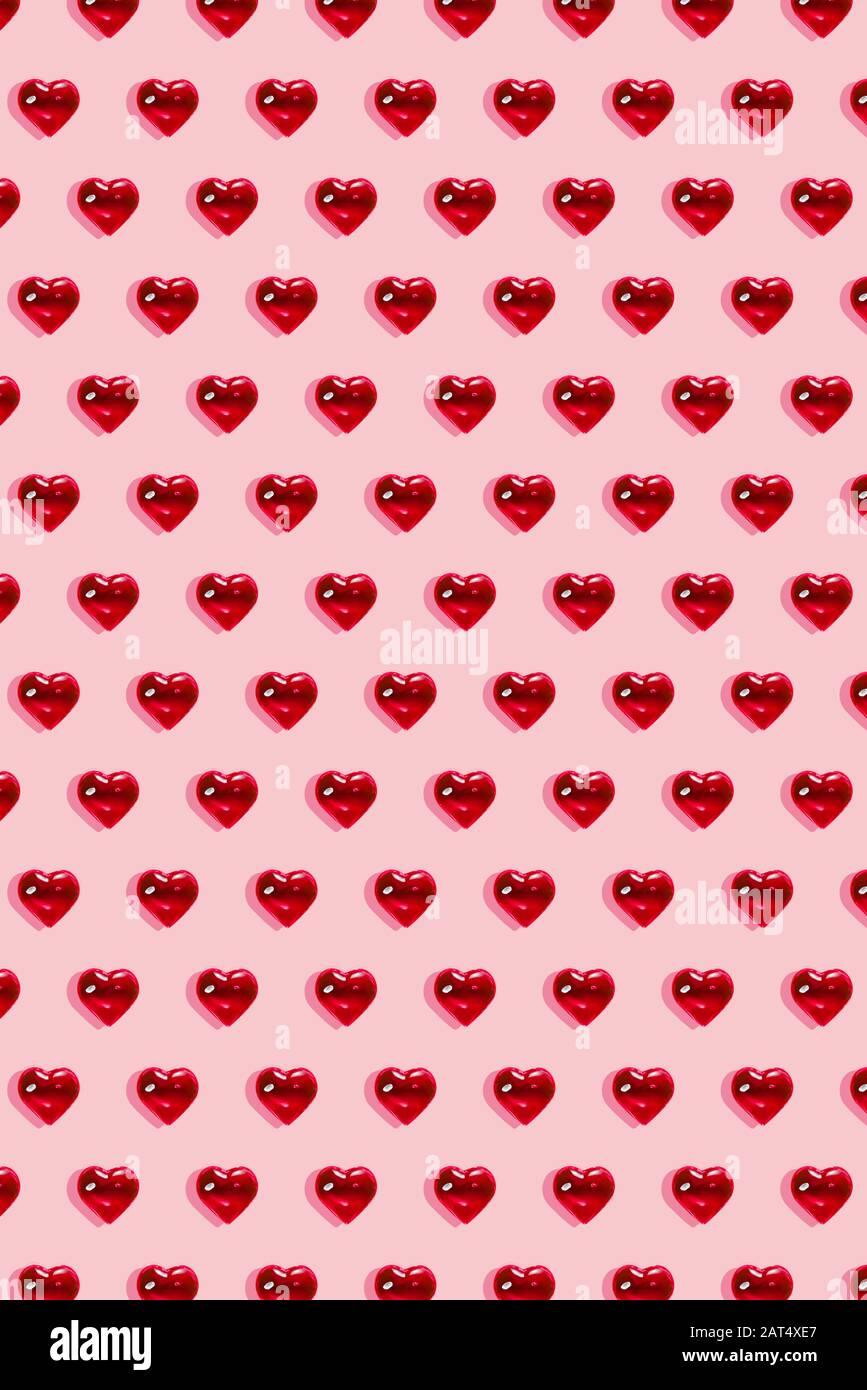 Valentine's day background. Pattern of glass red hearts on a pastel pink  background. Card minimalism, Symbol of love Stock Photo - Alamy
