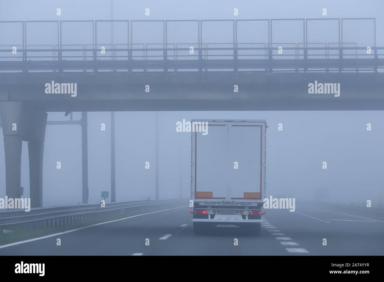 Traffic on the highway during thick morning fog Stock Photo - Alamy