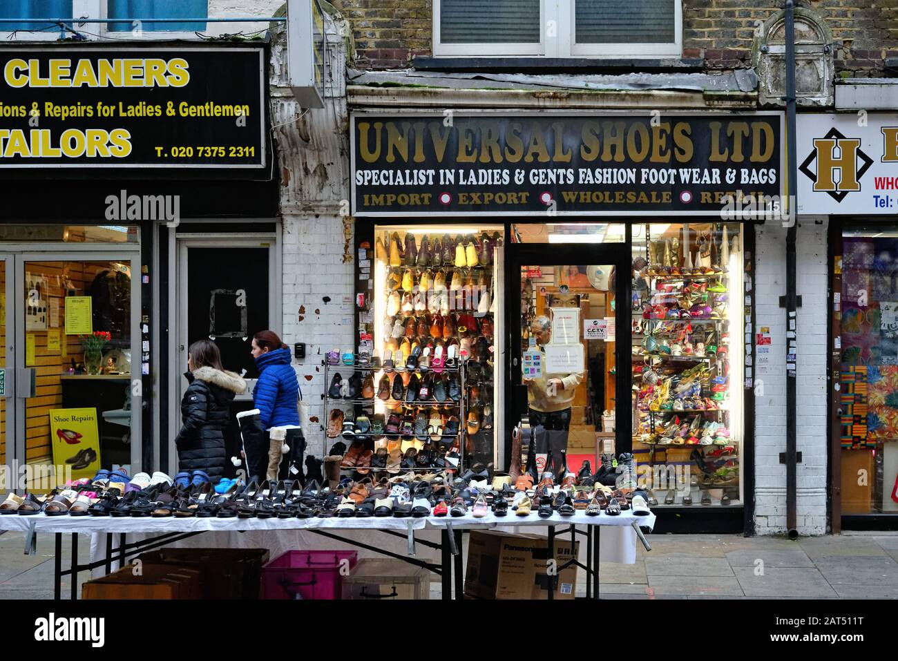 The front window display of an old style shoe shop on Wentworth Street Whitechapel East London England UK Stock Photo