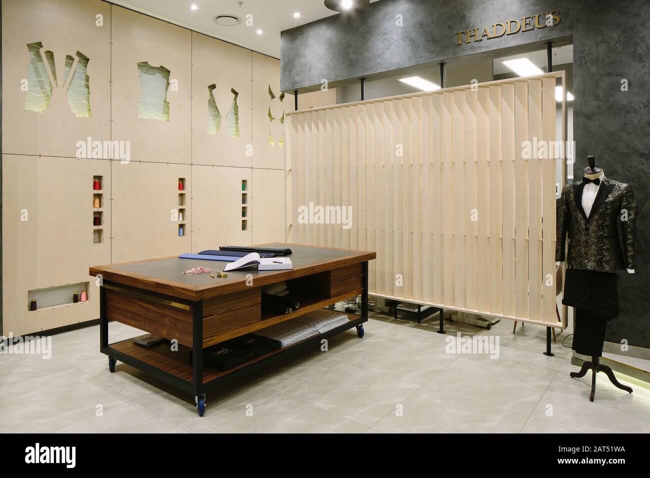 Tailory with bespoke workbench, screen and laser cut panelling