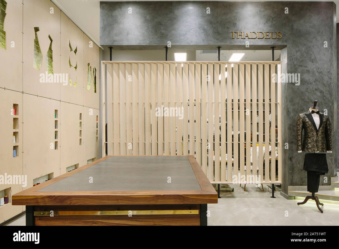 Screened tailory with bespoke workbench in the foreground and laser cut