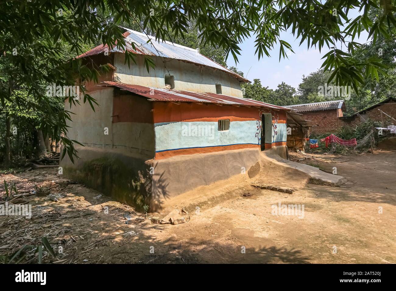 Rural Indian village with view of mud hut with thatched roof at Bolpur West Bengal, India Stock Photo