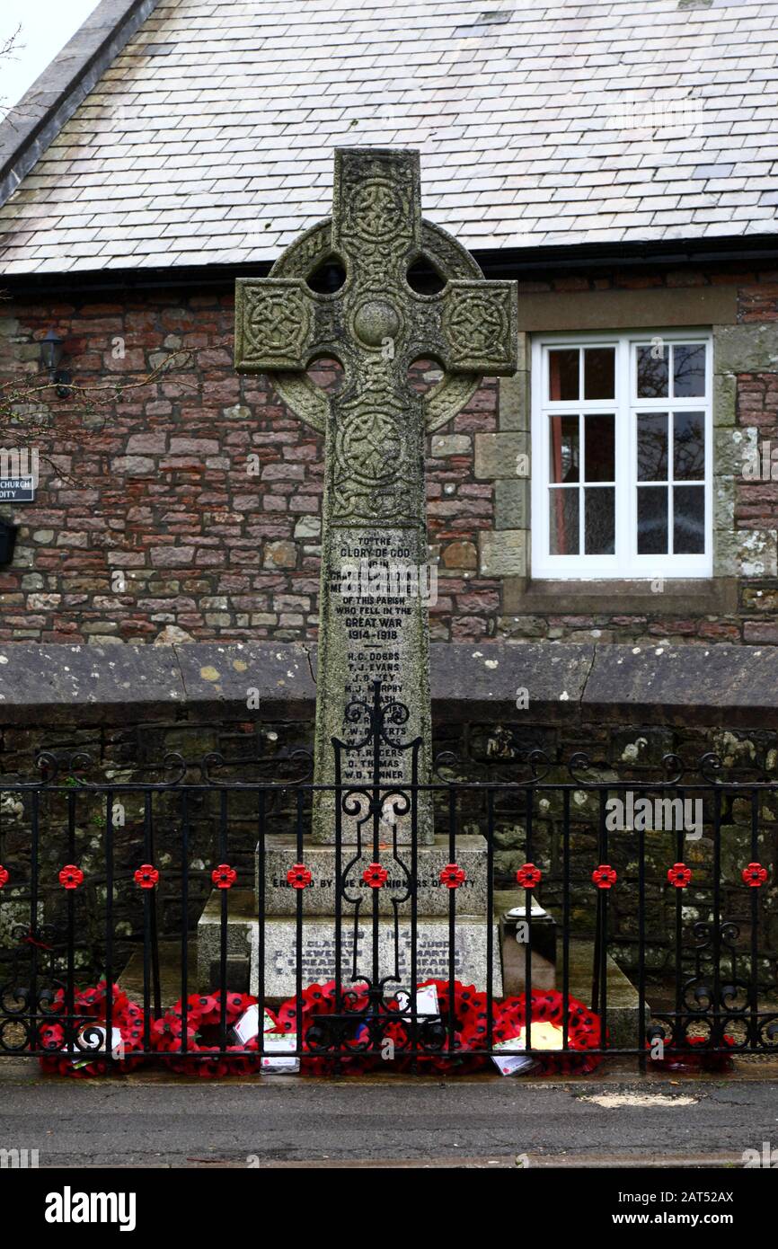 Poppy wreaths at base of war memorial in Coity village, Mid Glamorgan, Wales, UK Stock Photo