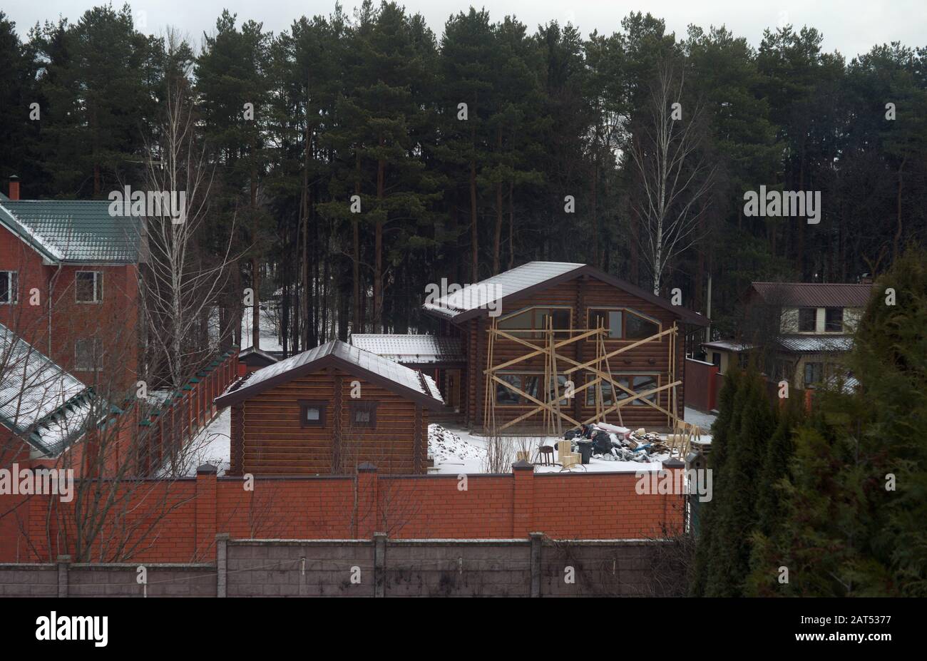 Scaffolding on the facade of a house under finishing works, winter ...