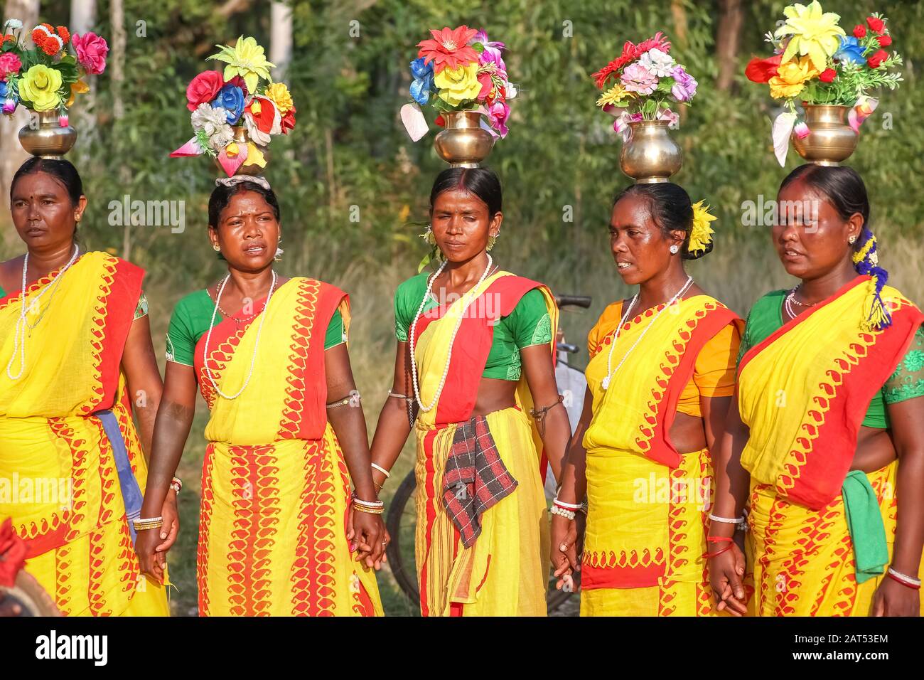 Tribal Indian women perform folk dance in a forested area at Bolpur Shantiniketan, West Bengal Stock Photo