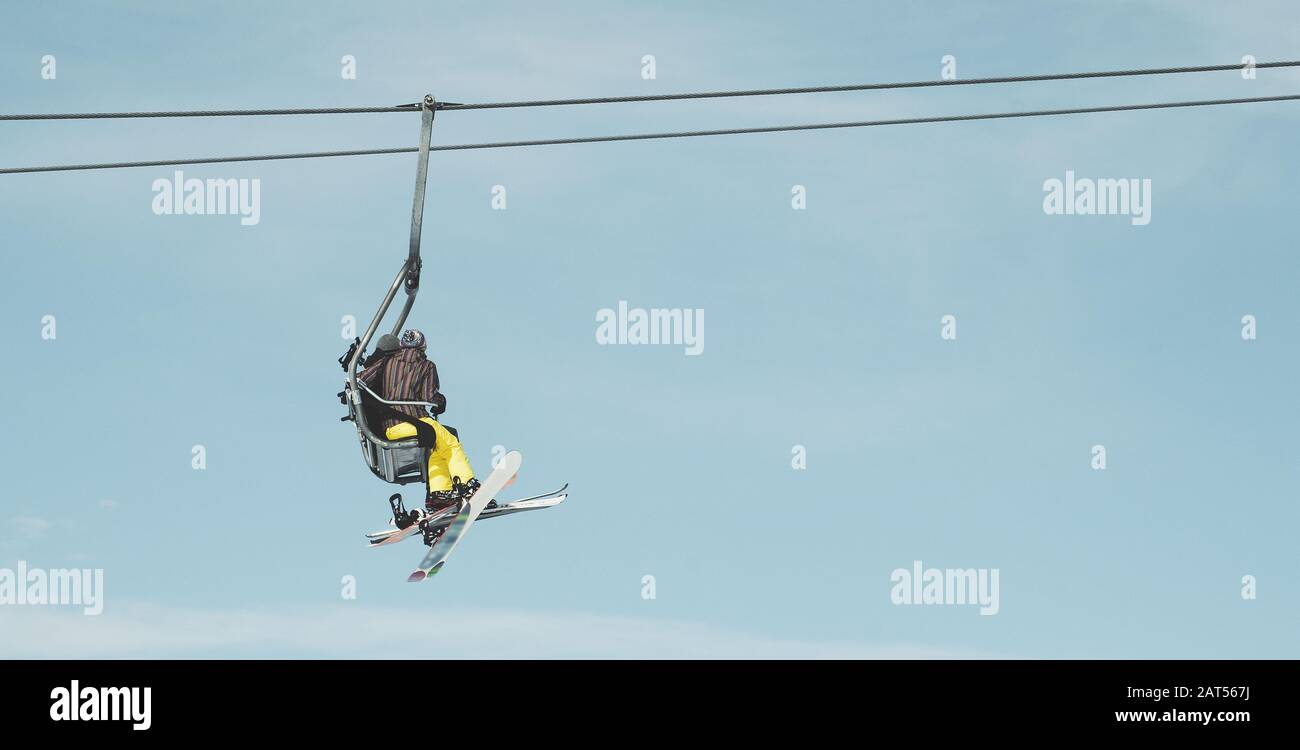 Low angle shot of people on a ropeway under the beautiful blue sky ...
