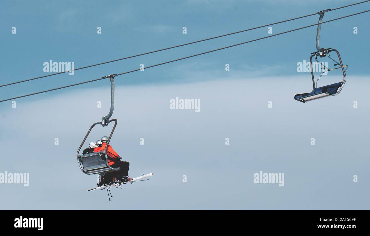 Low angle shot of people on a ropeway under the beautiful blue sky ...