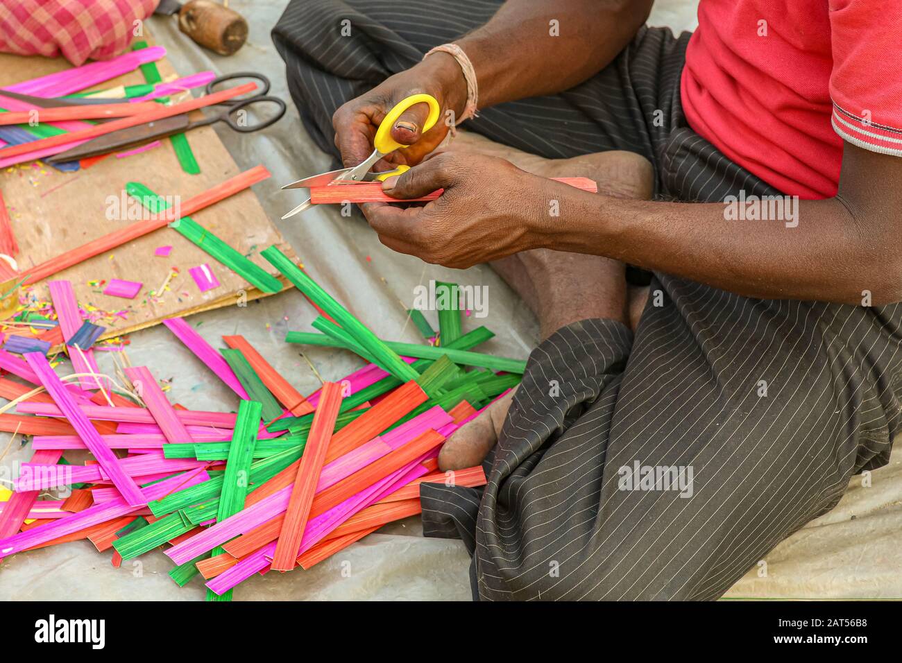 Local craftsman working on the creation of handicraft items for sale at