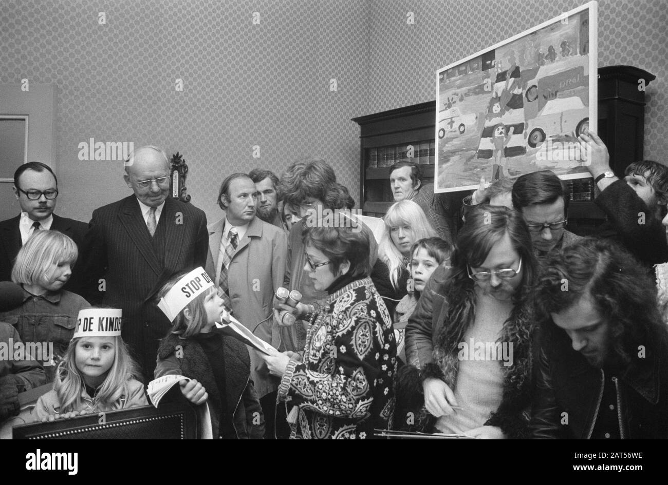 Demonstration action group Stop the Child Murder at the Binnenhof  Children with the painting to be offered to minister Westerterp Date: 6 February 1974 Location: The Hague, Zuid-Holland Keywords: actions, demonstrations, children, paintings Stock Photo