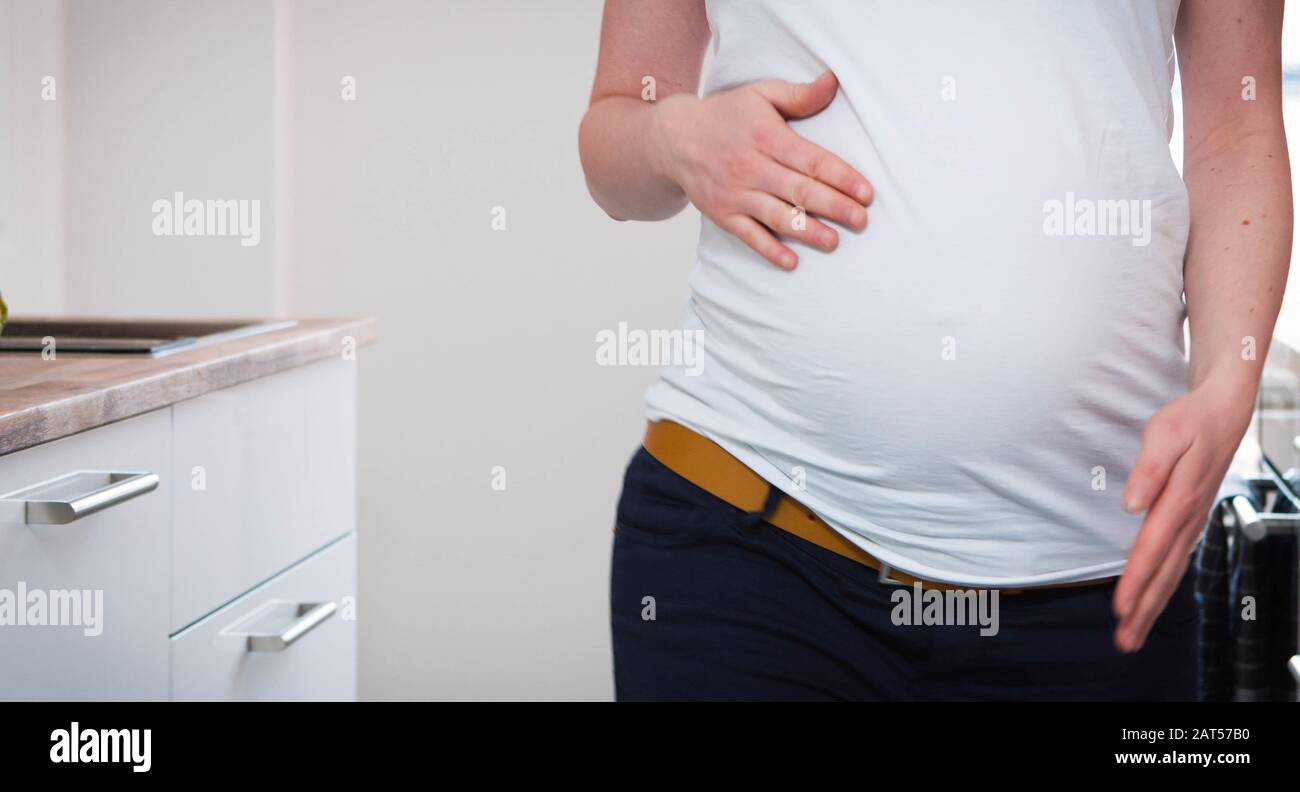 Beautiful shot of a pregnant woman's stomach with her hands around her