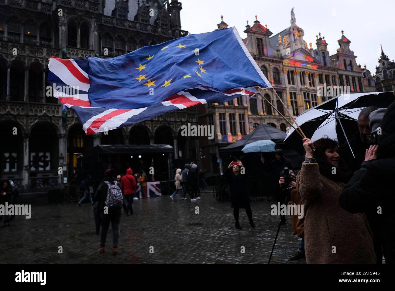 Brussels, Belgium. 30th Jan, 2020. A woman holds a European flag and a Union Jack flag on the Grand Place during an event to underline its long friendship with the British. Credit: ALEXANDROS MICHAILIDIS/Alamy Live News Stock Photo