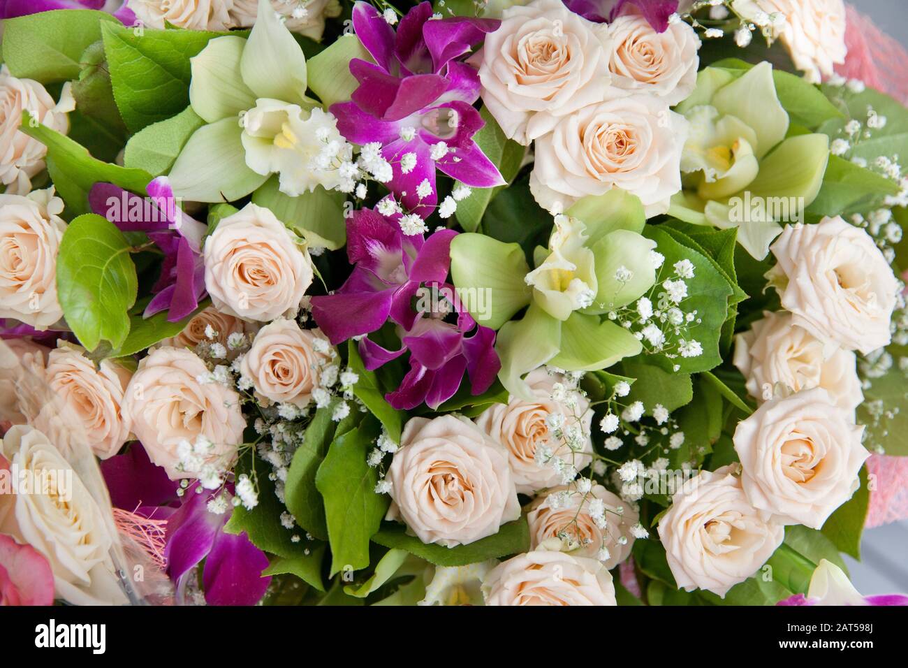 Bright composition of flowers. Bouquet of roses and orchids. Beautiful bouquet, floral background. Stock Photo
