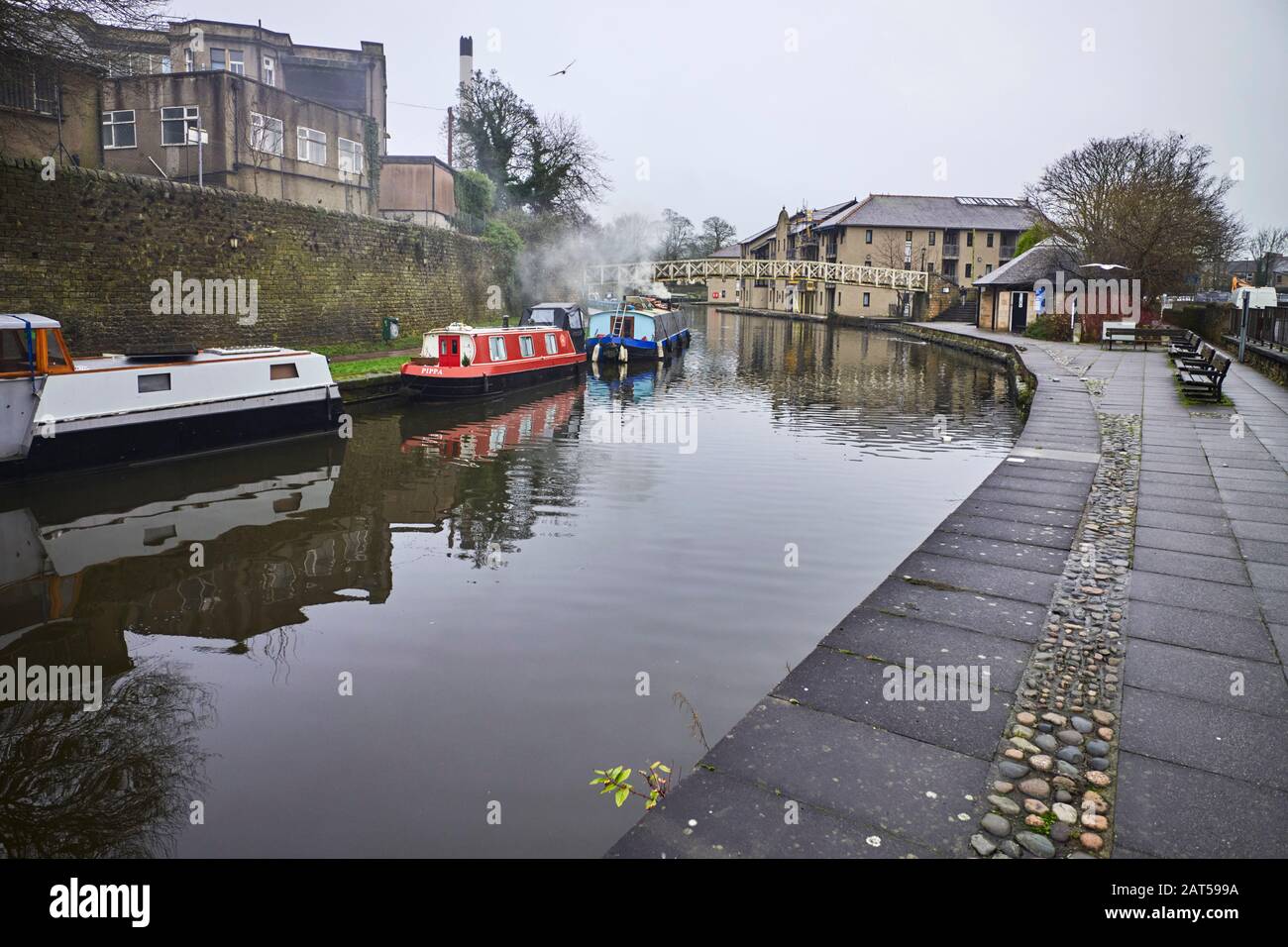 Canal at Lancaster with wide and narrowb beam boats on moorings Stock Photo