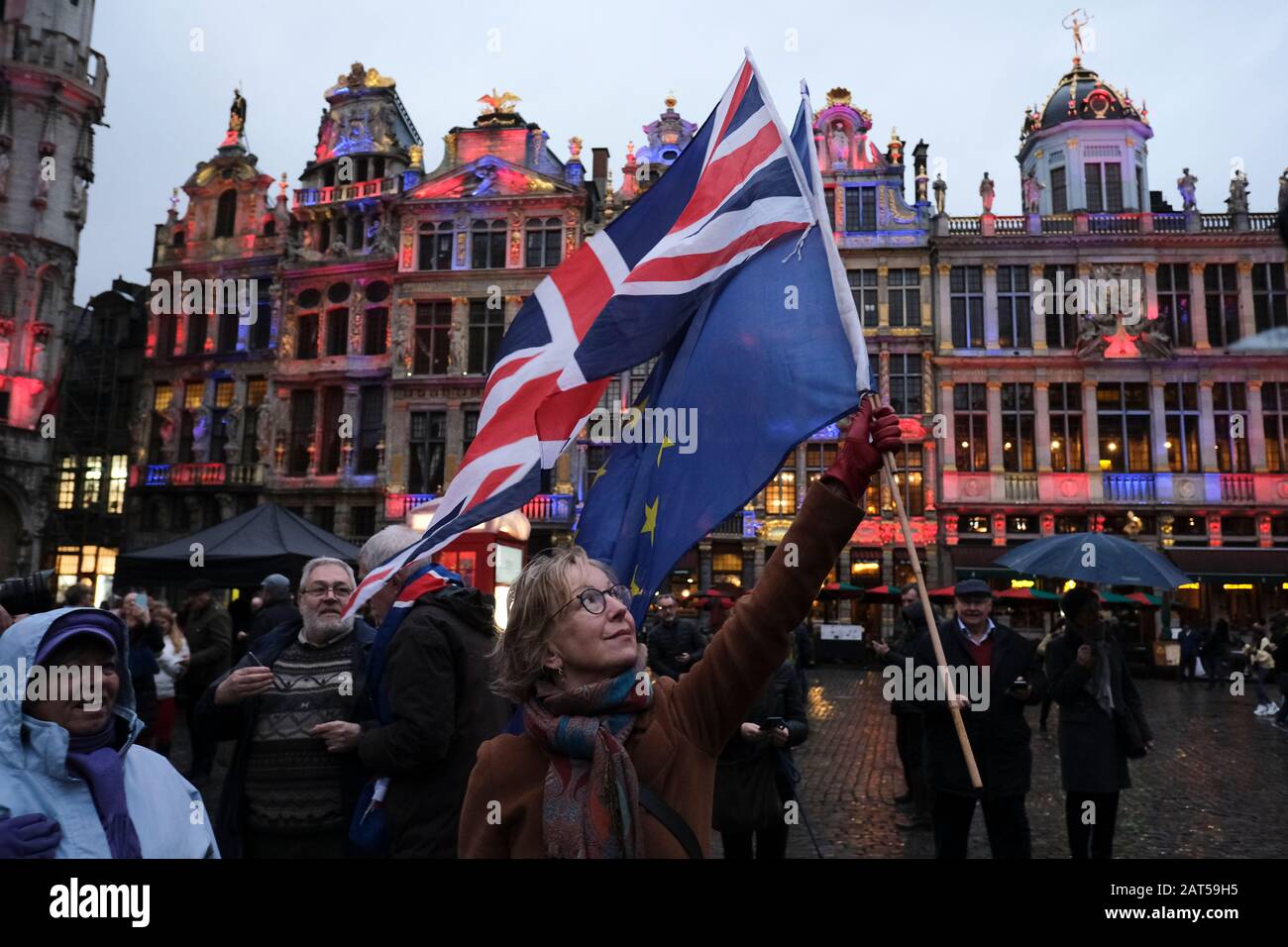 Brussels, Belgium. 30th Jan, 2020. A woman holds a European flag and a Union Jack flag on the Grand Place during an event to underline its long friendship with the British. Credit: ALEXANDROS MICHAILIDIS/Alamy Live News Stock Photo