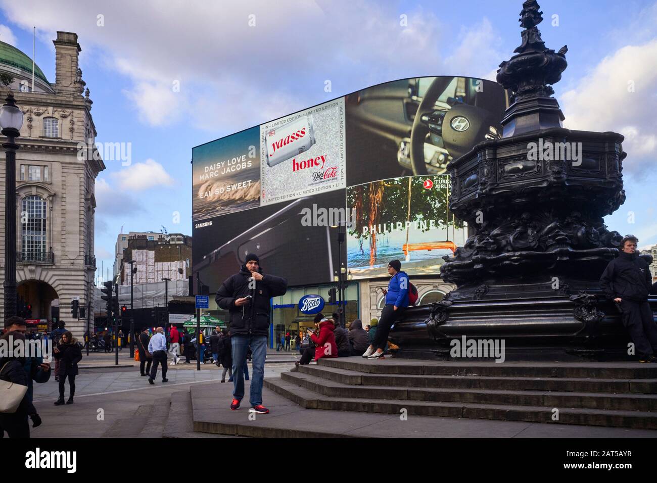 Tourists in winter Piccadilly Circus in London Stock Photo