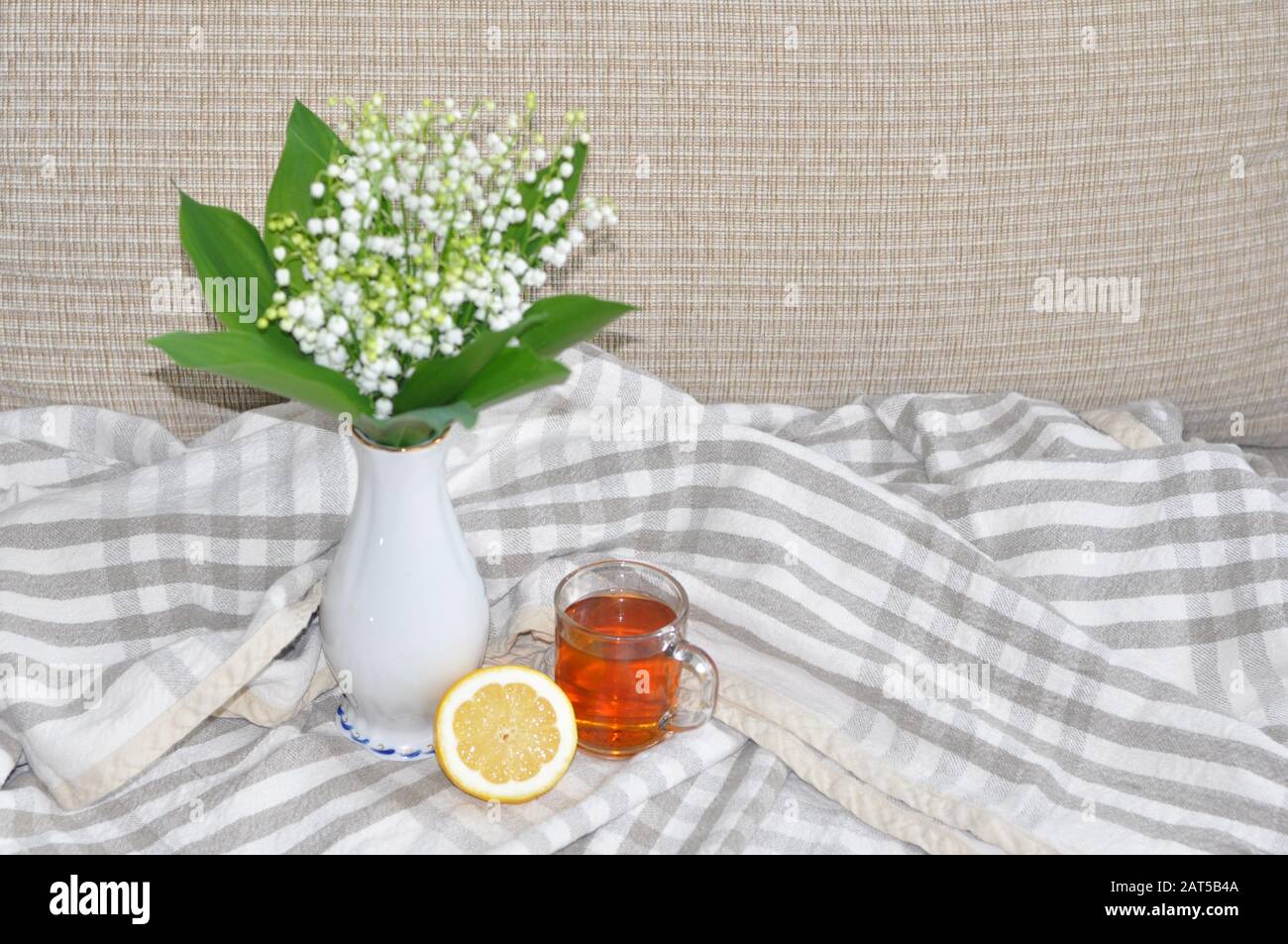 Still life a bouquet of white lilies of the valley in a glass vase ...