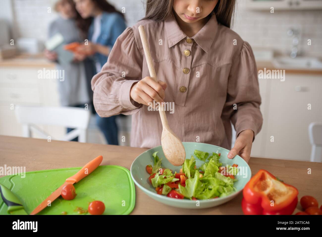 Stirring with a spoon chopped vegetable salad. Stock Photo