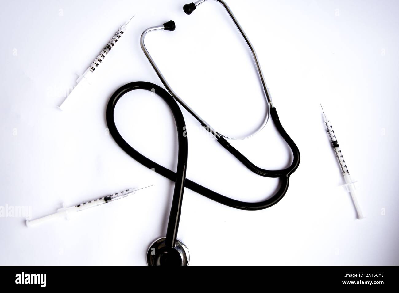 Medical stethoscope with syringes on white background Stock Photo - Alamy