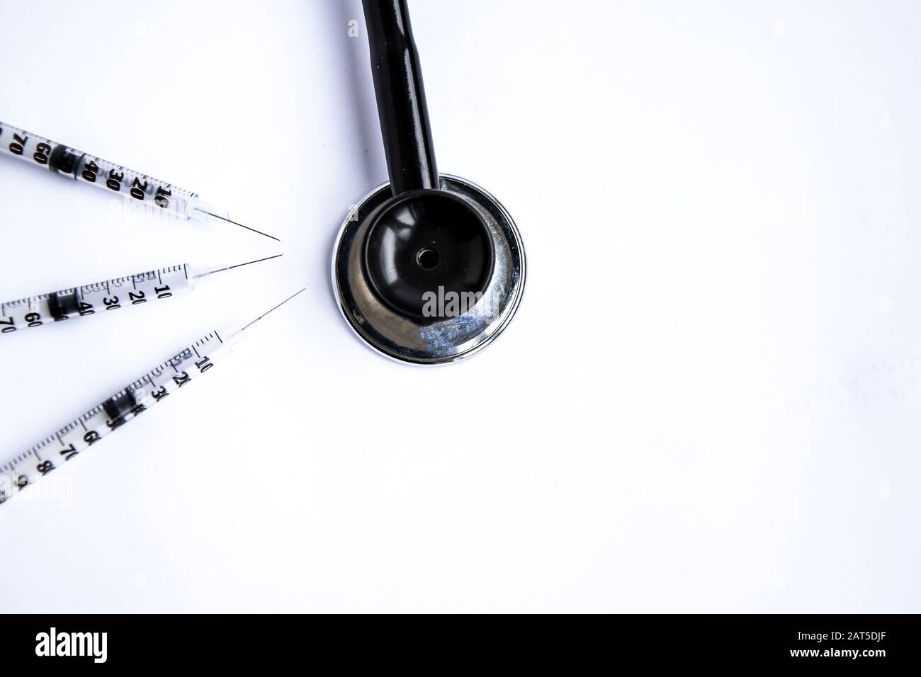 Medical stethoscope with syringes on white background Stock Photo - Alamy