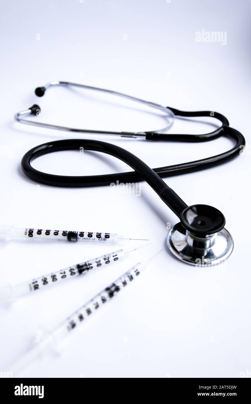Medical stethoscope with syringes on white background Stock Photo - Alamy
