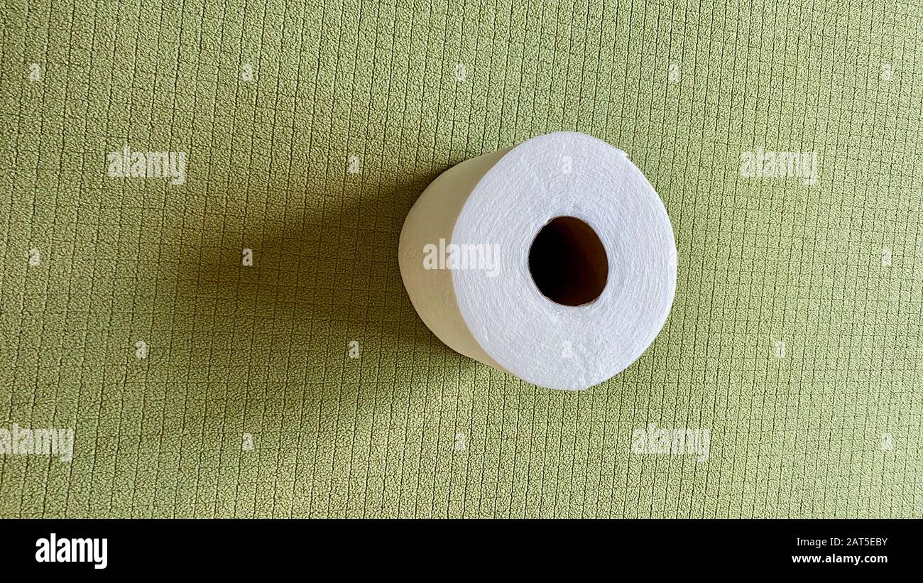 A fresh roll of toilet paper placed on a blanket Stock Photo