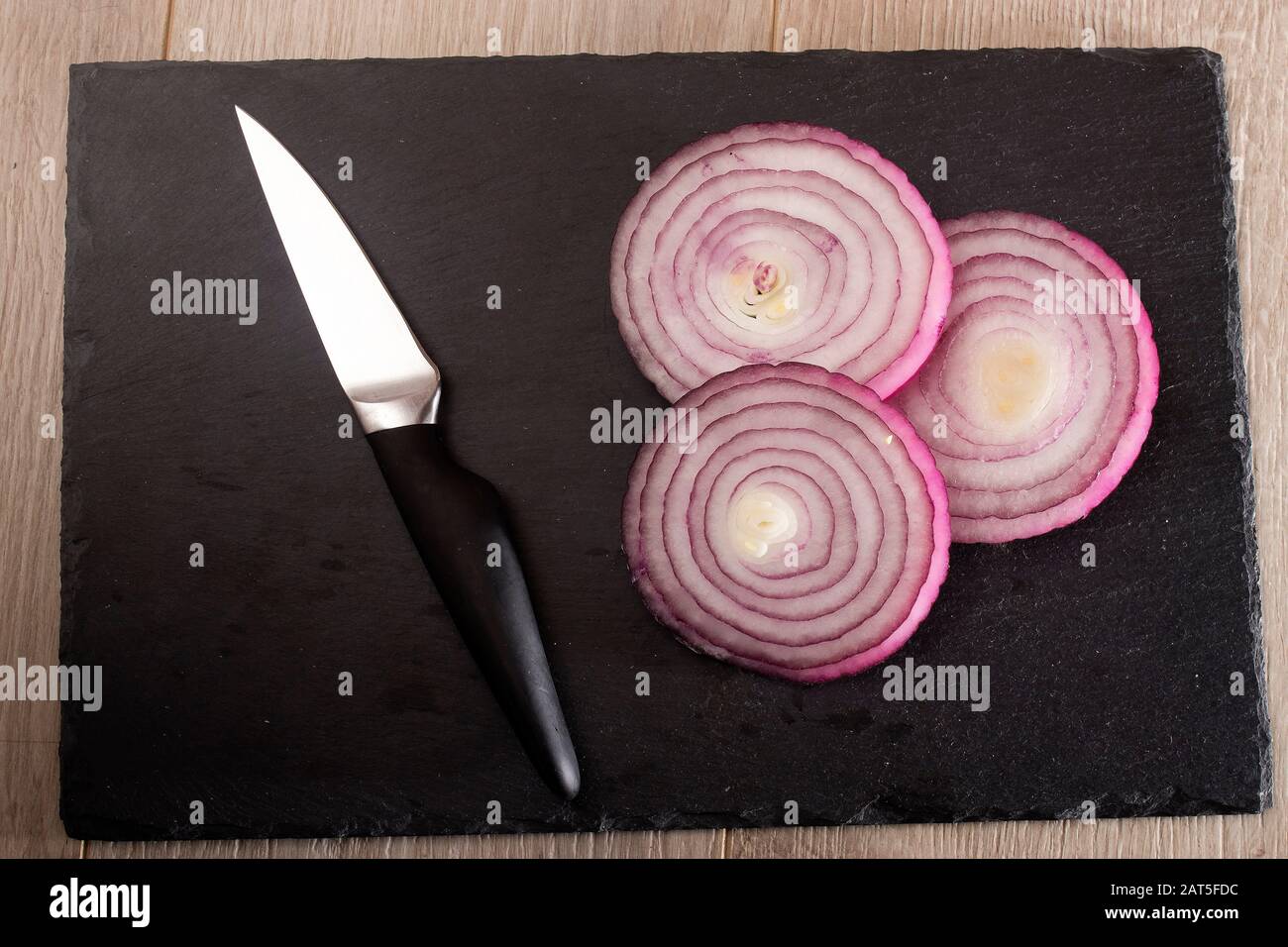 the red onion vegetable on the black background Stock Photo - Alamy