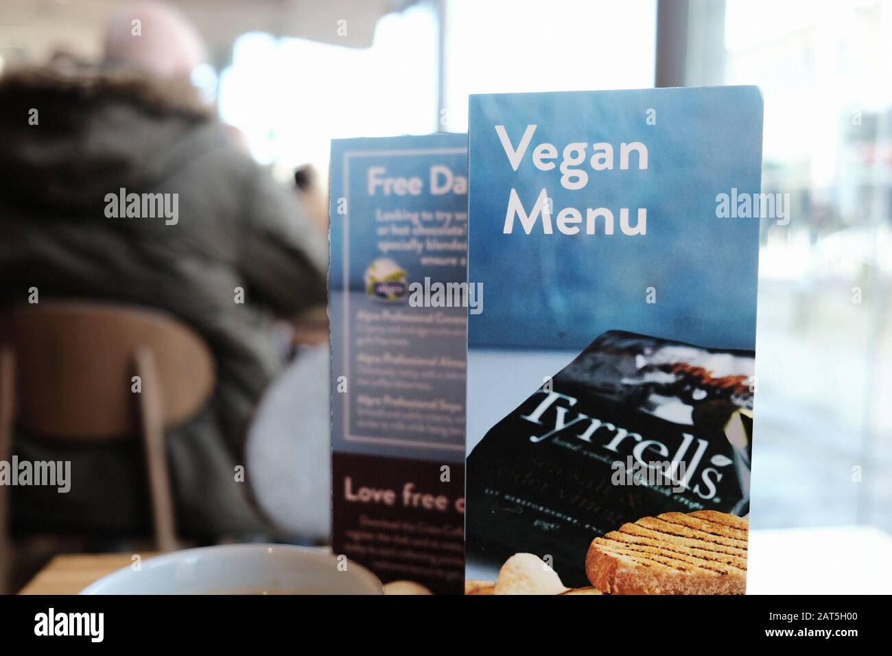 A vegan menu card on a table in a Costa coffee shop on a High St. The chain offers a range of dairy substitutes, snacks and soups to cater for Vegans Stock Photo