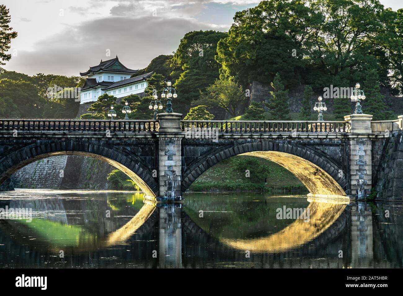 Nijubashi Bridge if Tokyo Imperial Palace reflected in water at sunset, Japan Stock Photo