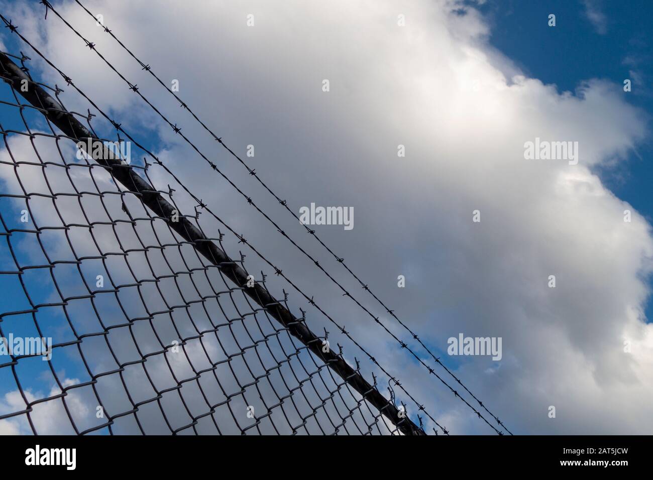 blocked off area with barbed wire fence Stock Photo