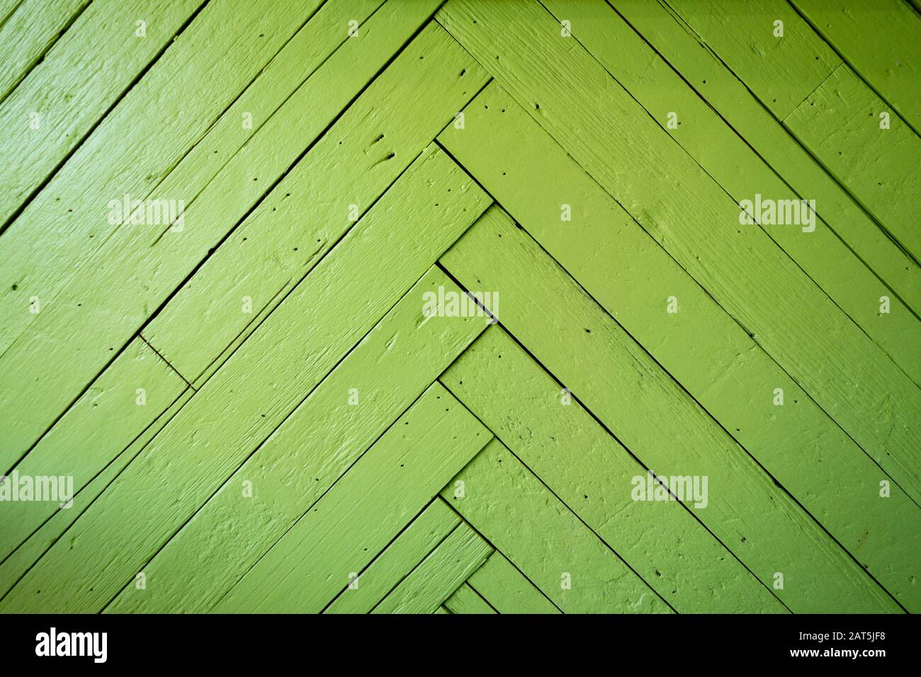 green chevron patterned wood planks on a wall Stock Photo