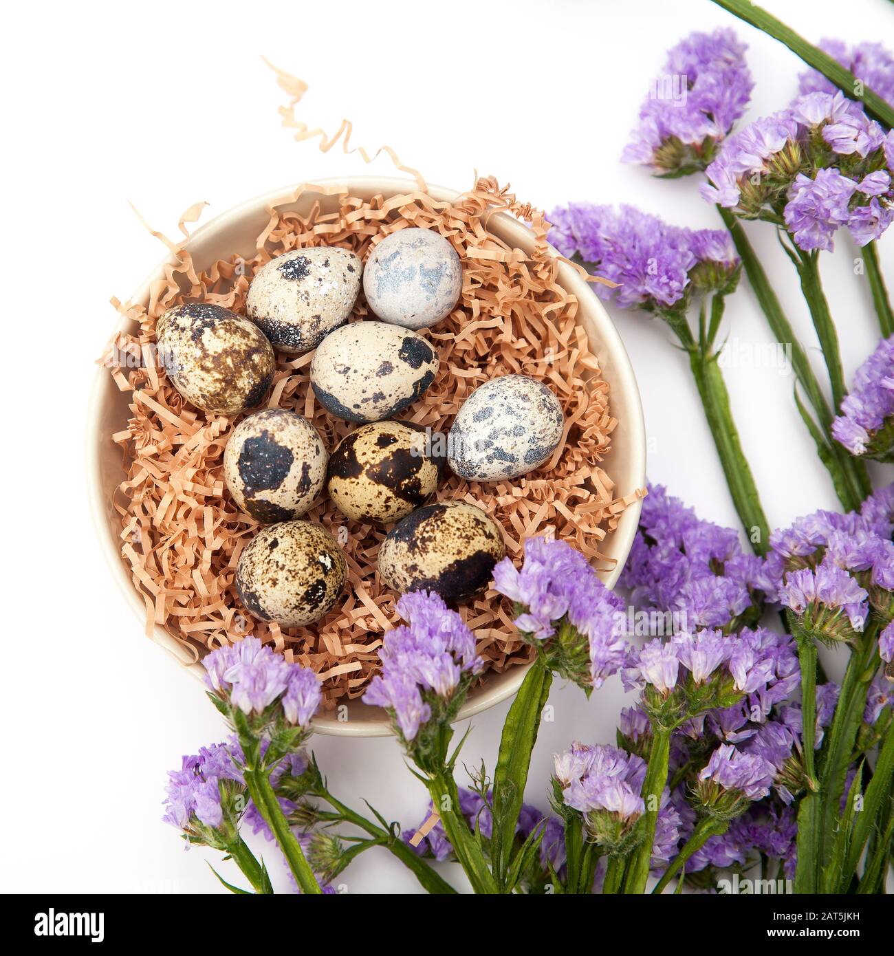 Limonium sinuatum Crystal Dark Blue. beautiful colorful fresh statice flower bouquet. Quail eggs in a chip in a white mask. Easter card. Stock Photo