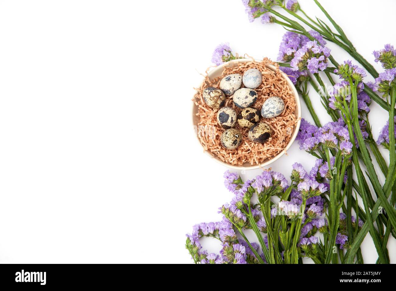 Limonium sinuatum Crystal Dark Blue. beautiful colorful fresh statice flower bouquet. Quail eggs in a chip in a white mask. Easter card. Stock Photo