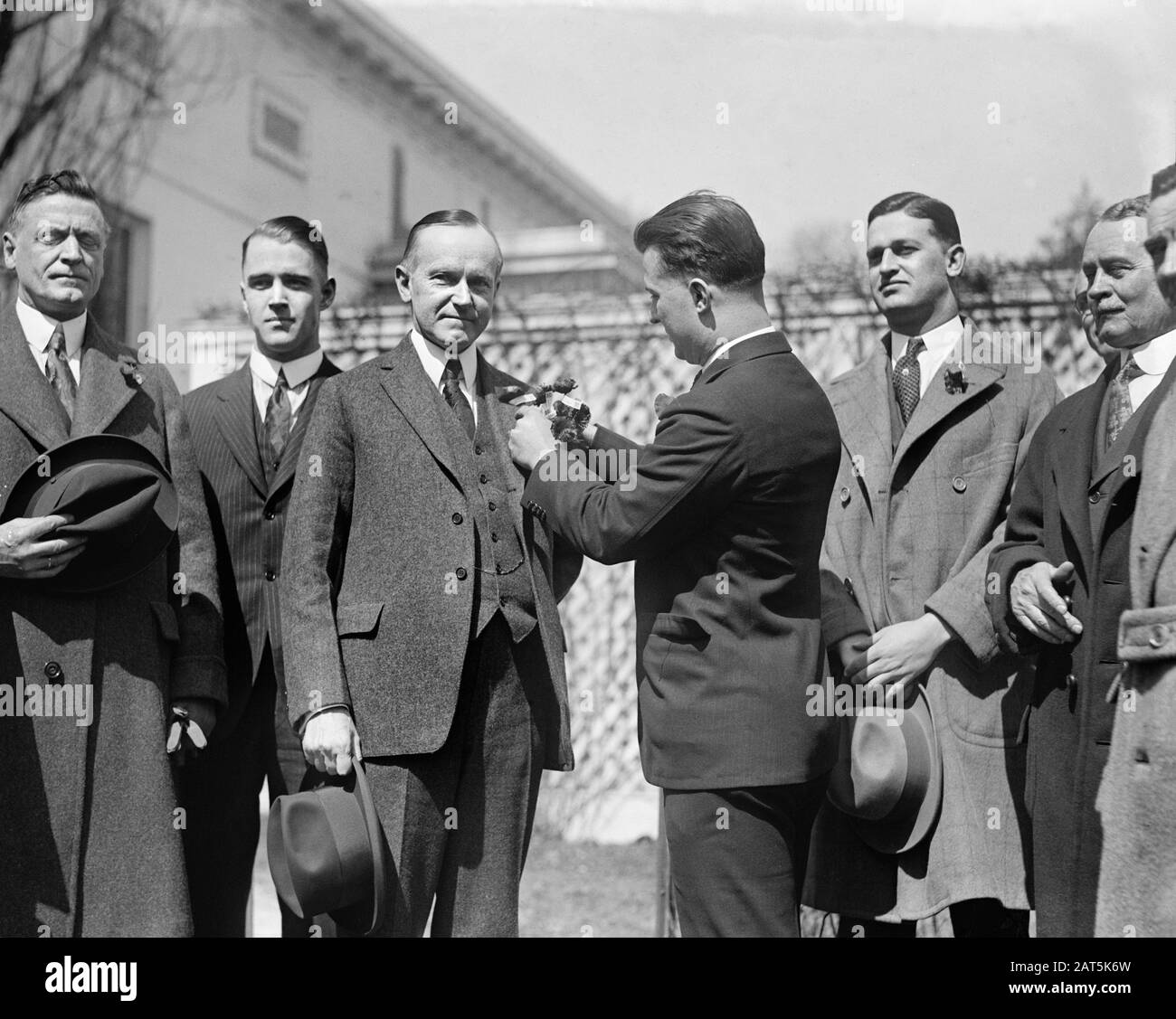 Captain William Homer Carroll, Member of the Veterans of Foreign Wars Delegation, pinning first VFW 'Buddy Poppy' on Lapel of U.S. President Calvin Coolidge, Washington, D.C., USA, National Photo Company, March 19, 1924 Stock Photo