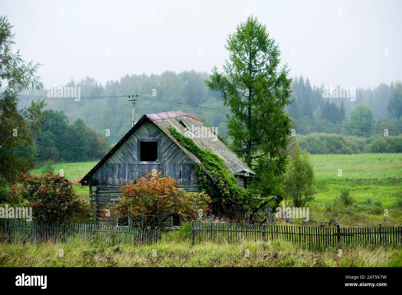 old abandoned old wooden house without windows with a partially missing fence Stock Photo Alamy
