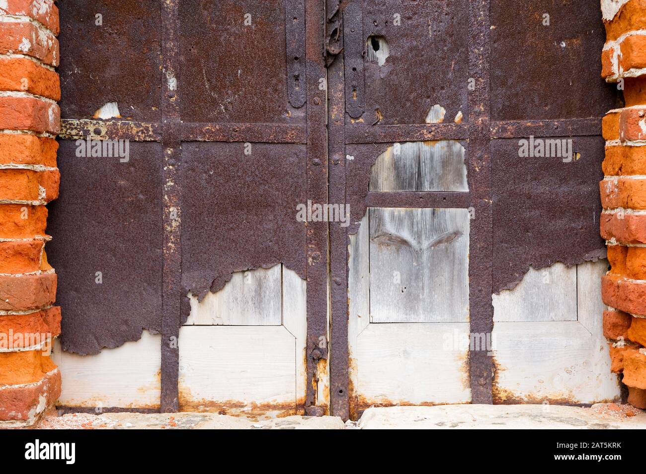 Smashed Wall Entry blocked entrance to an abandoned antique building with crumbling walls ...