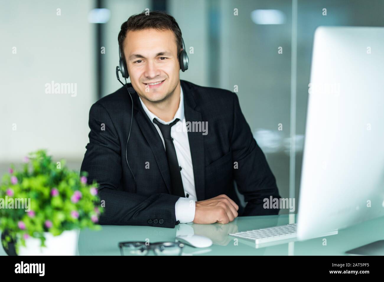Businessman In The Office On The Phone With Headset Skype