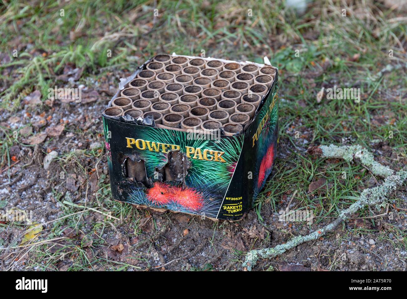 Fired barrage or cake firework left on a field after New Year's celebration Stock Photo