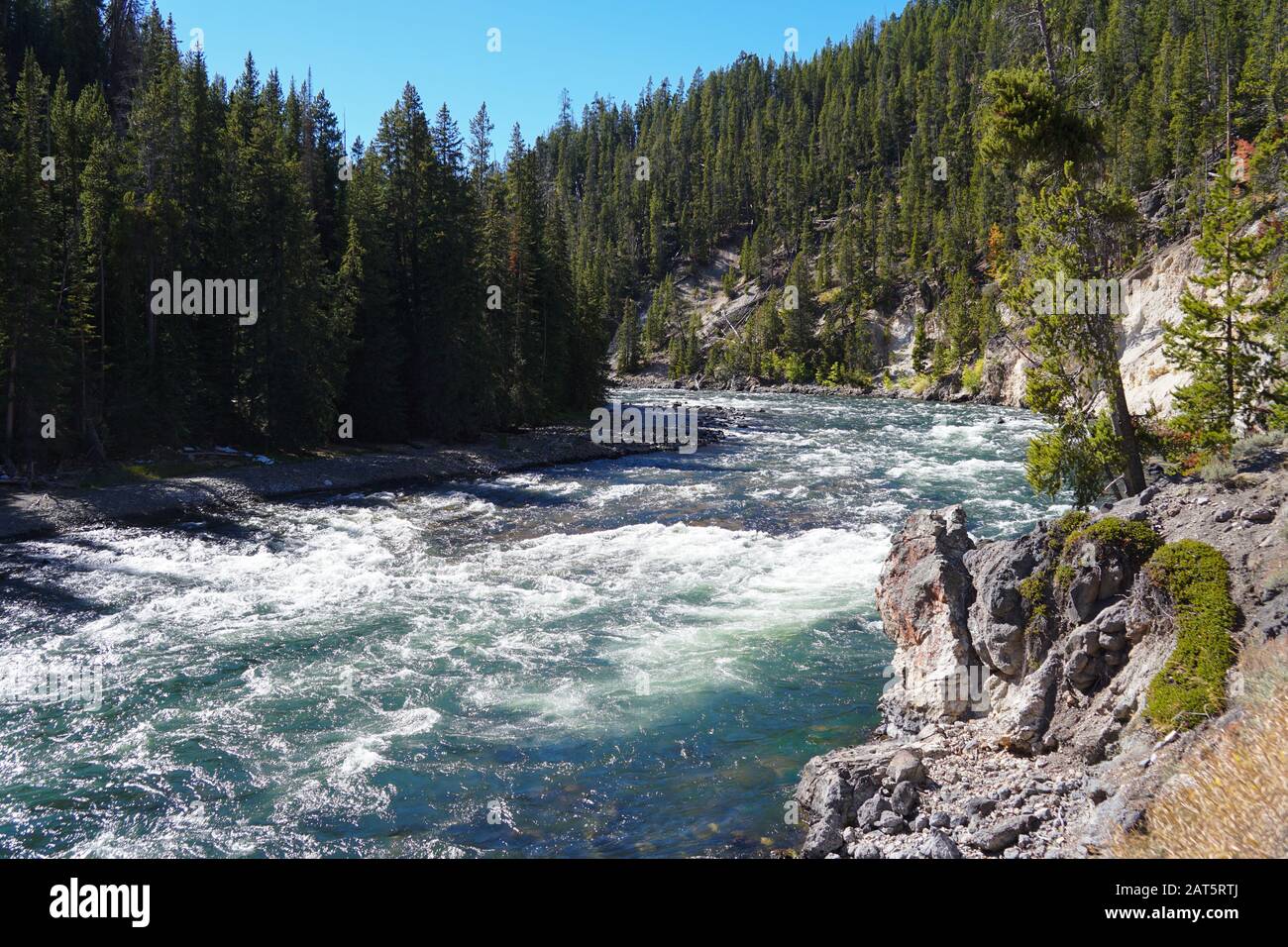 The Yellowstone River traveling quickly right before it reaches the top of the Lower Falls. Stock Photo