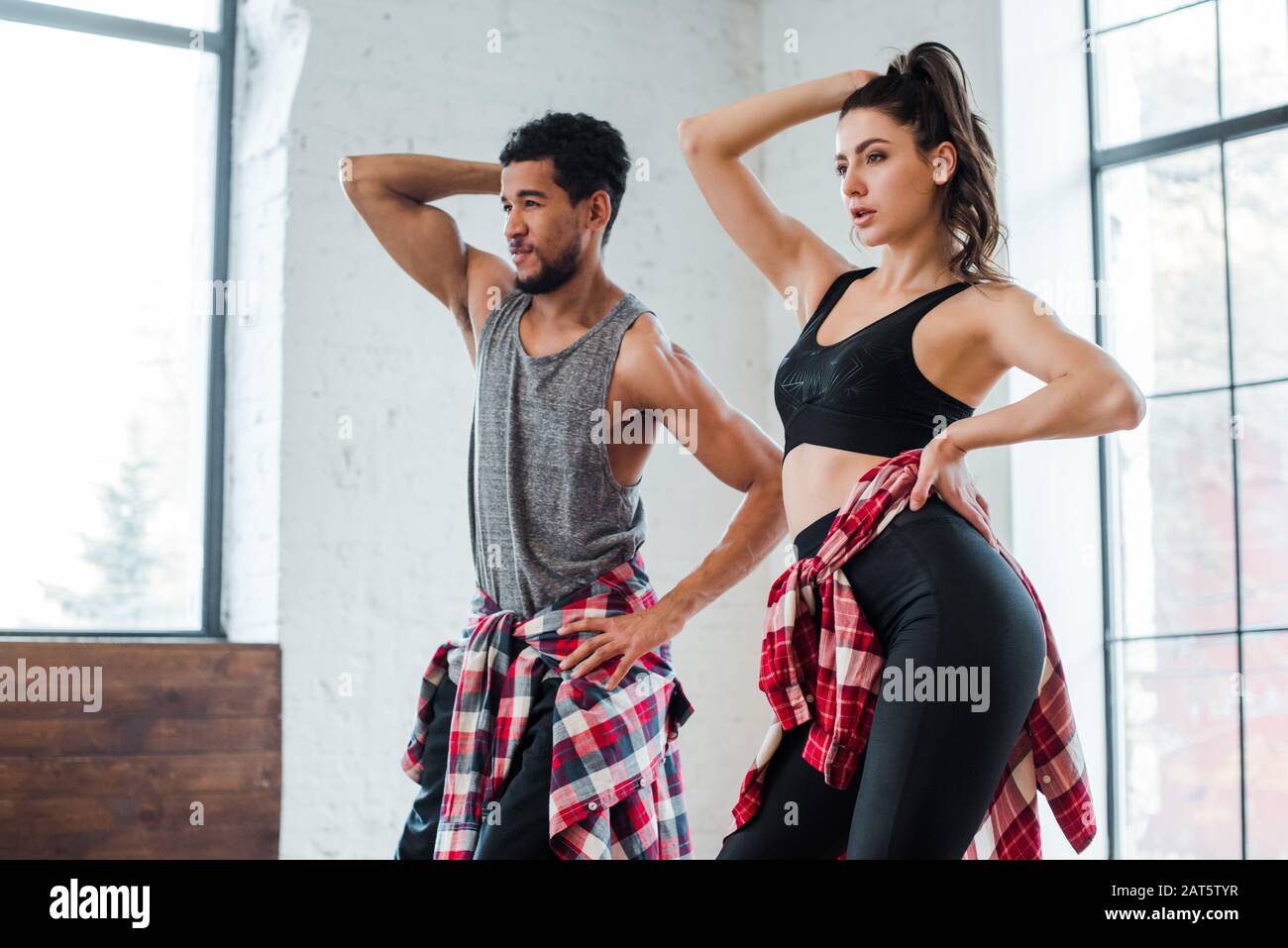 attractive girl and handsome african american man with hands on hips dancing jazz funk Stock Photo