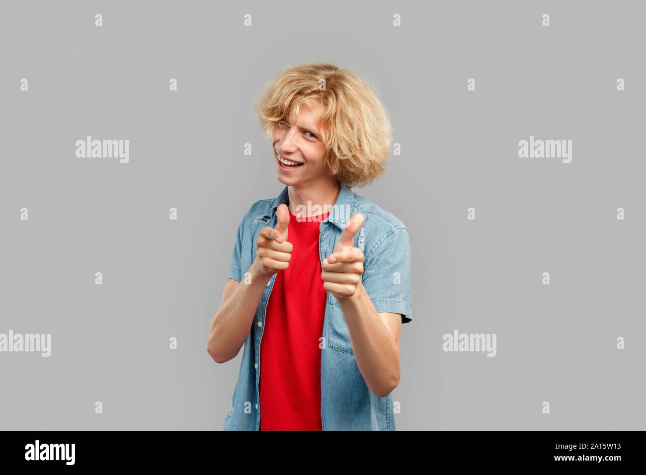 Young man smiling wide and pointing at camera Stock Photo