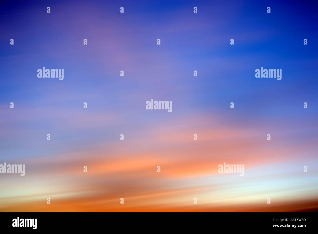 Abstract blurred Background of Beautiful, colorful sunset clouds against the perfect blue sky Stock Photo