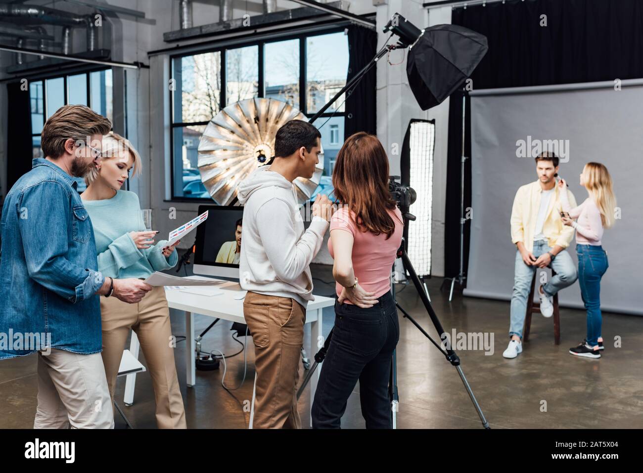 backstage in modern photo studio with model, art director and