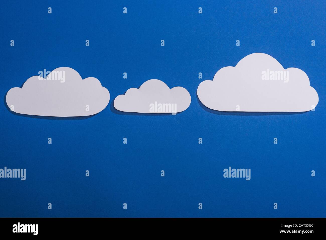 top view of white paper cut clouds on blue background Stock Photo - Alamy