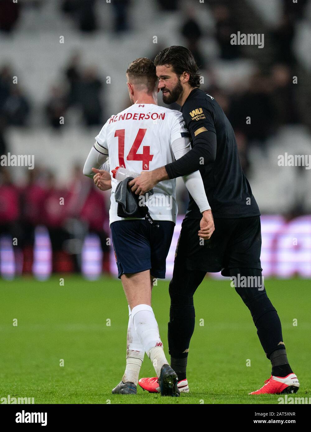 Goalkeeper Alisson Becker & Jordan Henderson of Liverpool at full time during the Premier League match between West Ham United and Liverpool at the Ol Stock Photo